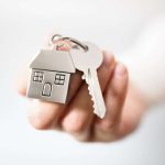 Real estate agent giving house keys
